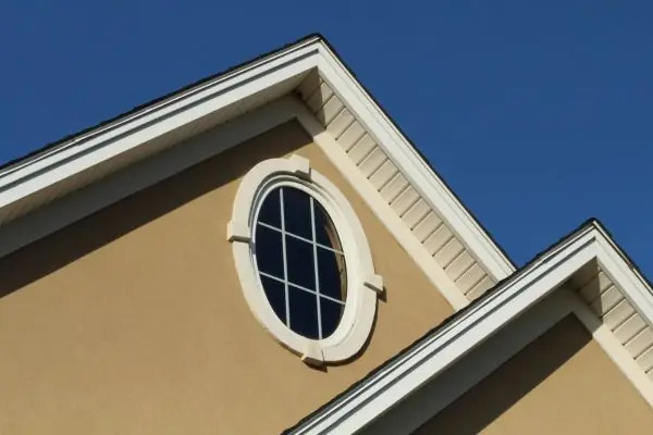 brown stucco exterior with round window